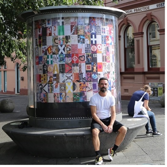 Artist Ian Thomas sitting in front of his Art Seat installation
